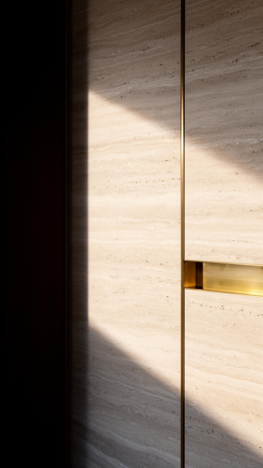 Travertine and brass interior detail in raking morning light
